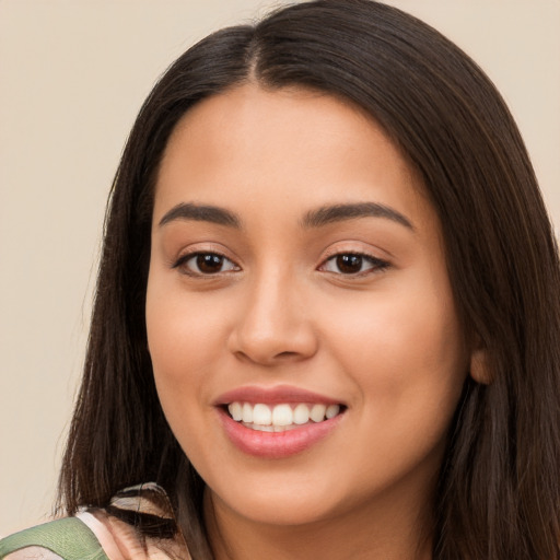 Joyful white young-adult female with long  brown hair and brown eyes