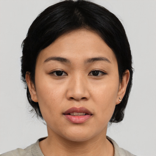 Joyful asian young-adult female with medium  black hair and brown eyes