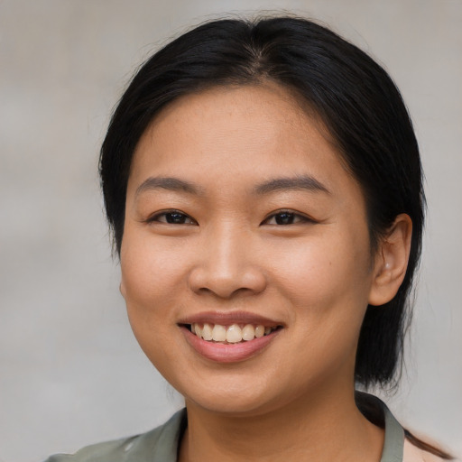Joyful asian young-adult female with medium  brown hair and brown eyes