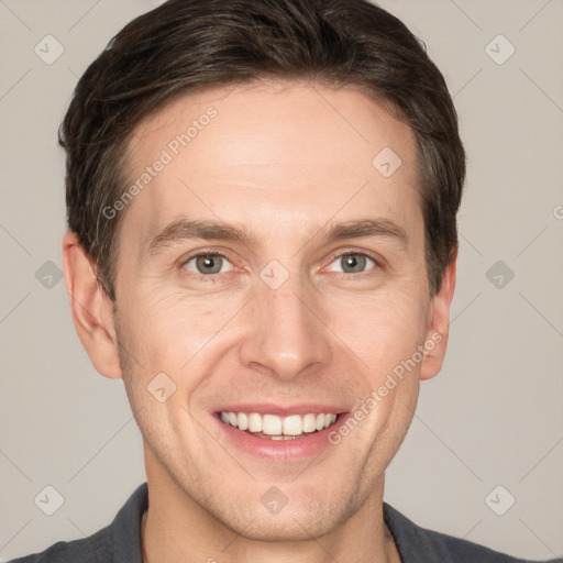 Joyful white adult male with short  brown hair and grey eyes