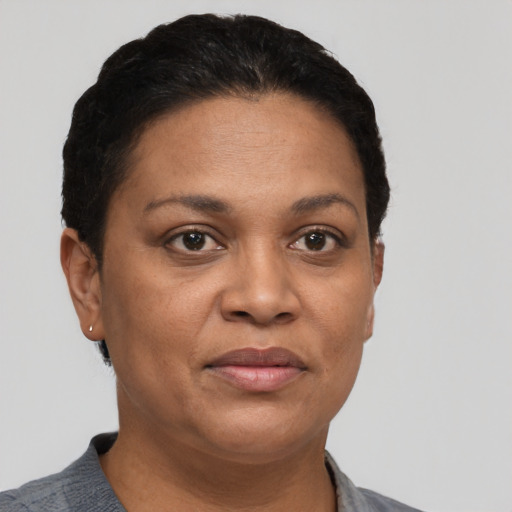Joyful latino adult female with short  black hair and brown eyes