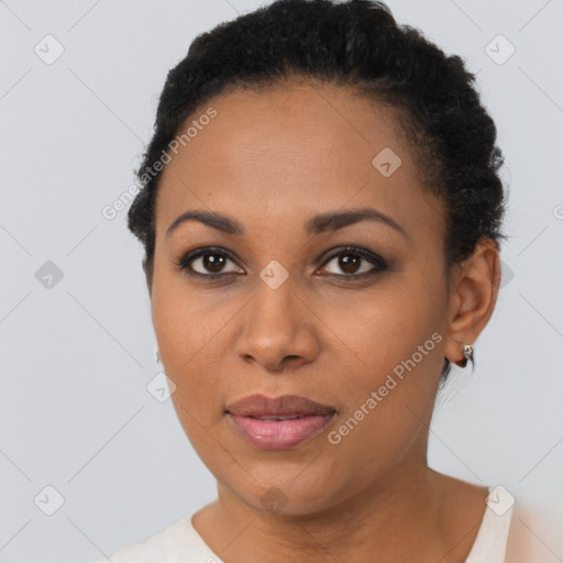 Joyful black young-adult female with short  black hair and brown eyes