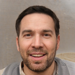 Joyful white adult male with short  brown hair and brown eyes