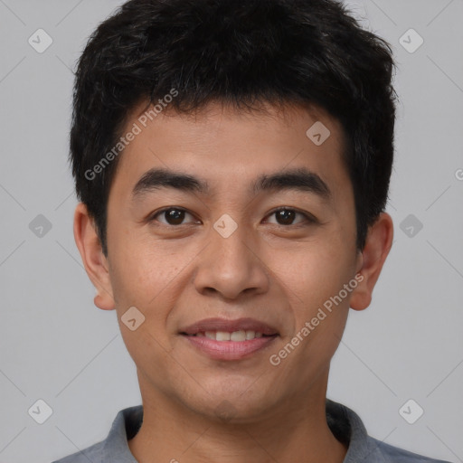 Joyful asian young-adult male with short  black hair and brown eyes