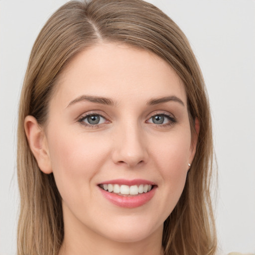 Joyful white young-adult female with long  brown hair and grey eyes