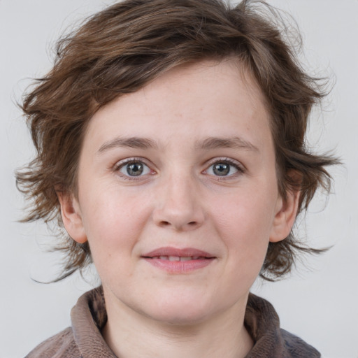 Joyful white young-adult female with medium  brown hair and blue eyes