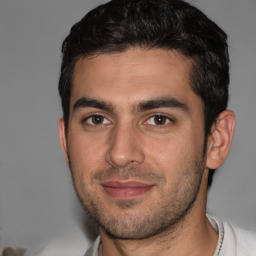 Joyful white young-adult male with short  black hair and brown eyes