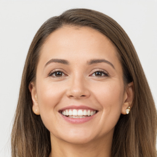 Joyful white young-adult female with long  brown hair and brown eyes