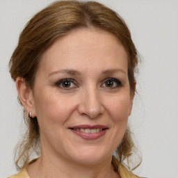 Joyful white adult female with medium  brown hair and brown eyes