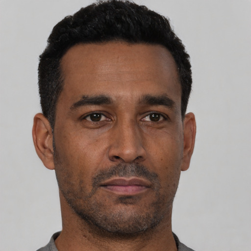 Neutral black adult male with short  black hair and brown eyes