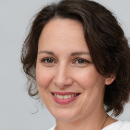 Joyful white adult female with medium  brown hair and brown eyes