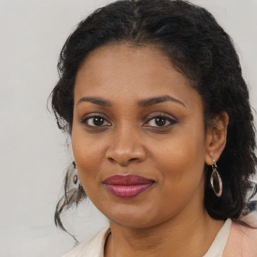 Joyful black young-adult female with medium  brown hair and brown eyes