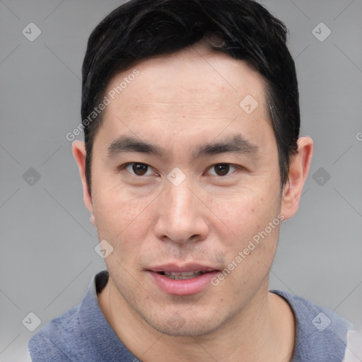 Joyful asian young-adult male with short  black hair and brown eyes