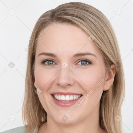 Joyful white young-adult female with medium  brown hair and green eyes