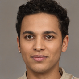 Joyful latino young-adult male with short  brown hair and brown eyes