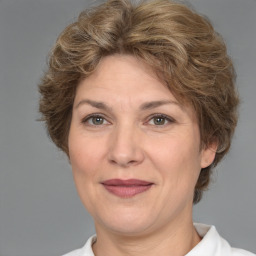 Joyful white adult female with short  brown hair and brown eyes