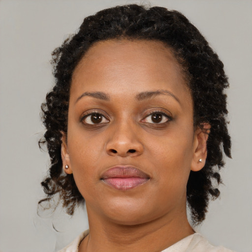 Joyful black young-adult female with medium  brown hair and brown eyes