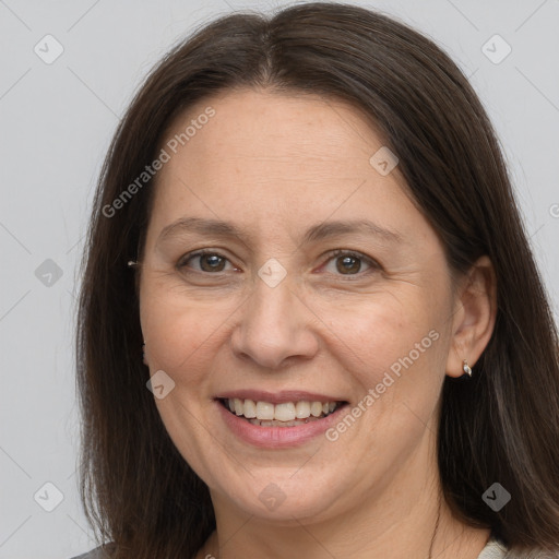 Joyful white adult female with long  brown hair and brown eyes