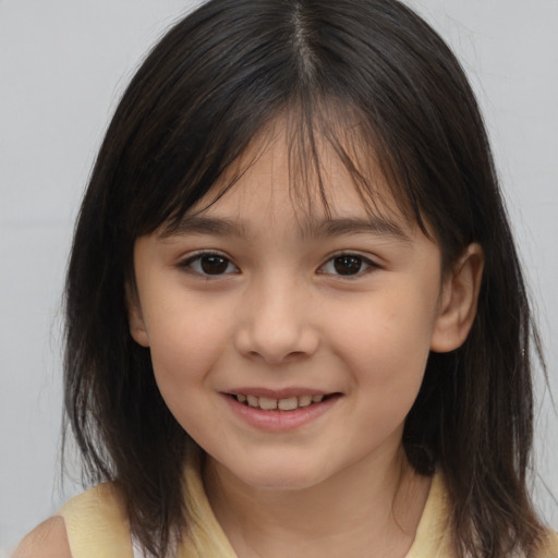 Joyful white child female with medium  brown hair and brown eyes