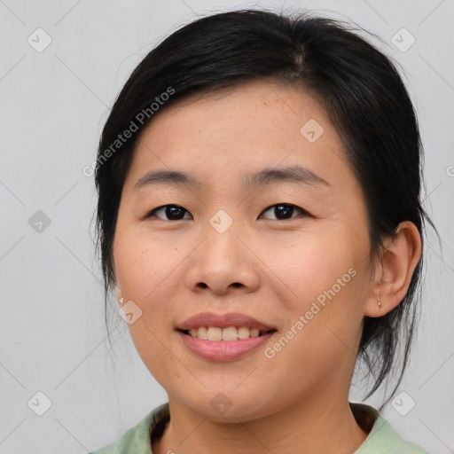 Joyful asian young-adult female with medium  brown hair and brown eyes