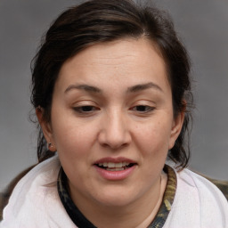 Joyful white adult female with medium  brown hair and brown eyes
