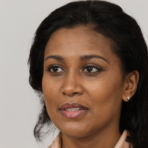 Joyful black adult female with medium  black hair and brown eyes