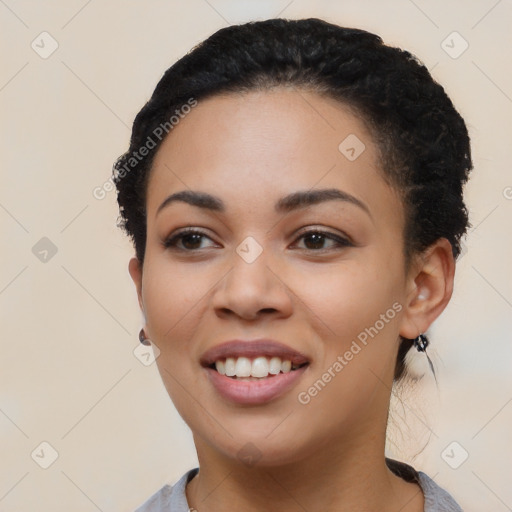 Joyful latino young-adult female with short  black hair and brown eyes