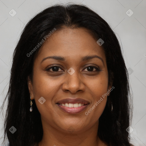 Joyful black young-adult female with long  brown hair and brown eyes