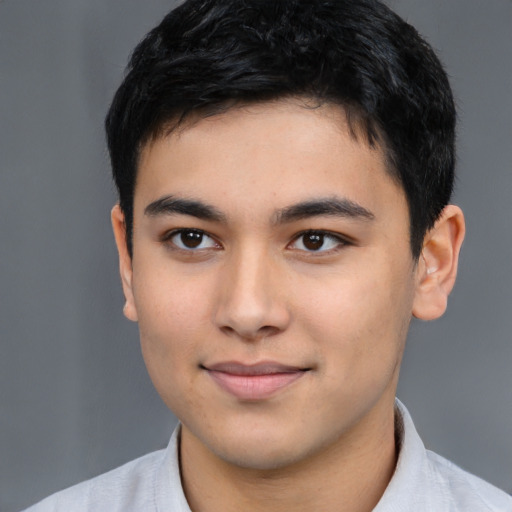 Joyful white young-adult male with short  black hair and brown eyes