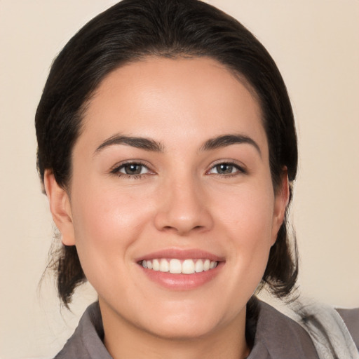 Joyful white young-adult female with medium  brown hair and brown eyes