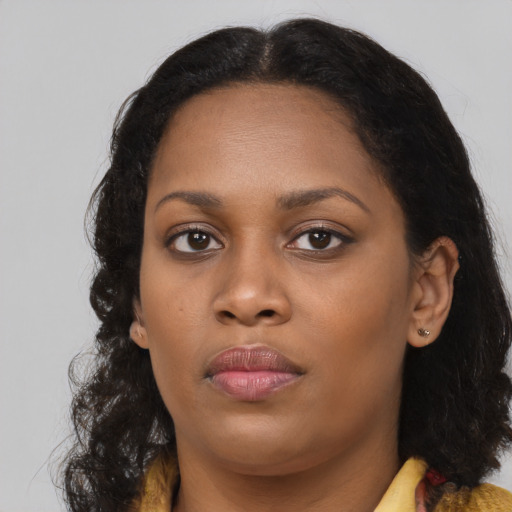 Neutral black young-adult female with long  brown hair and brown eyes
