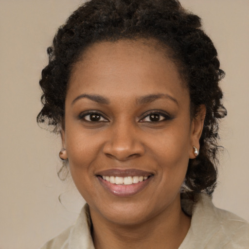 Joyful black young-adult female with medium  brown hair and brown eyes