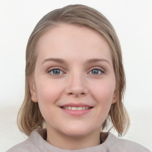 Joyful white young-adult female with medium  brown hair and blue eyes