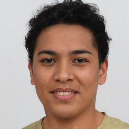 Joyful latino young-adult male with short  brown hair and brown eyes