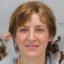 Joyful white adult female with medium  brown hair and blue eyes