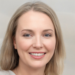 Joyful white young-adult female with long  brown hair and blue eyes