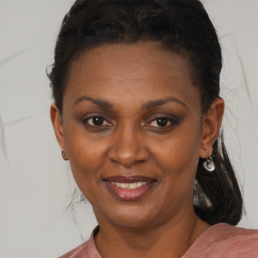 Joyful black young-adult female with medium  brown hair and brown eyes