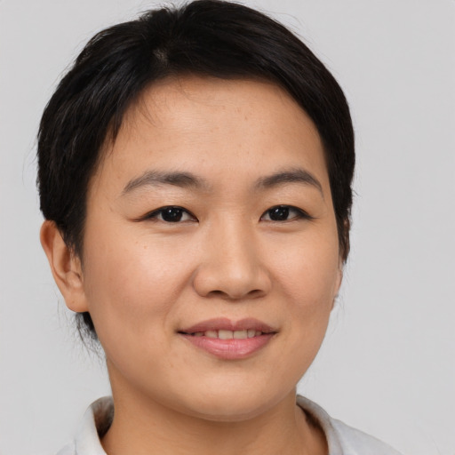 Joyful asian young-adult female with medium  brown hair and brown eyes