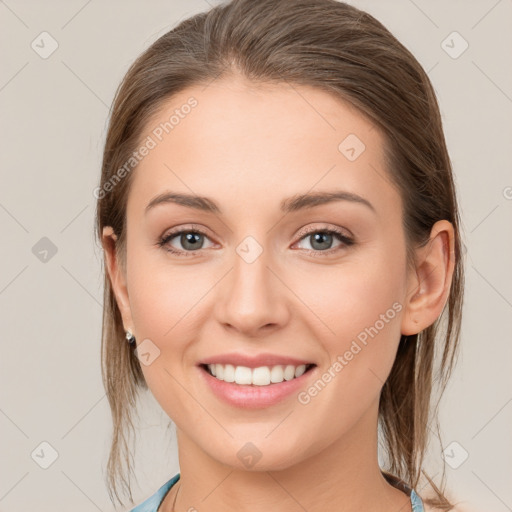 Joyful white young-adult female with medium  brown hair and grey eyes