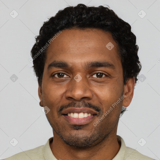 Joyful black young-adult male with short  black hair and brown eyes