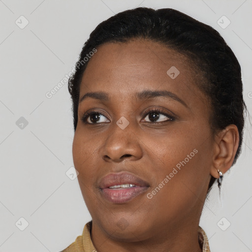 Joyful black young-adult female with short  black hair and brown eyes