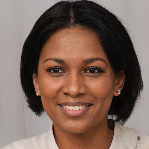 Joyful black young-adult female with medium  black hair and brown eyes