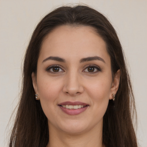 Joyful white young-adult female with long  brown hair and brown eyes