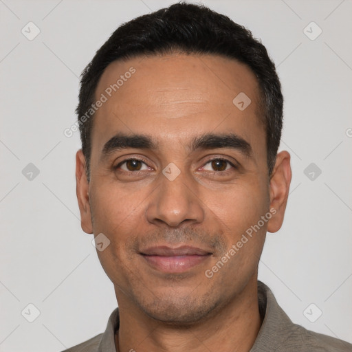 Joyful white young-adult male with short  black hair and brown eyes