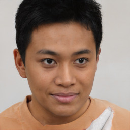 Joyful asian young-adult male with short  brown hair and brown eyes