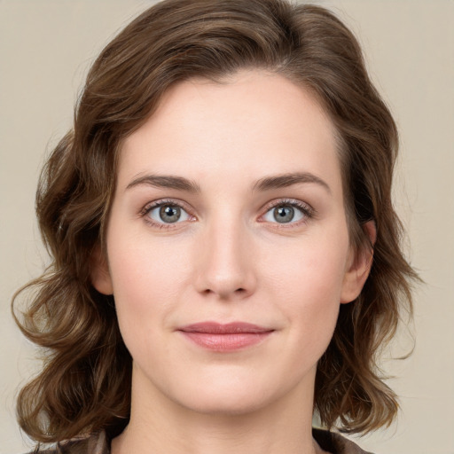 Joyful white young-adult female with medium  brown hair and green eyes