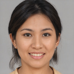 Joyful asian young-adult female with medium  brown hair and brown eyes