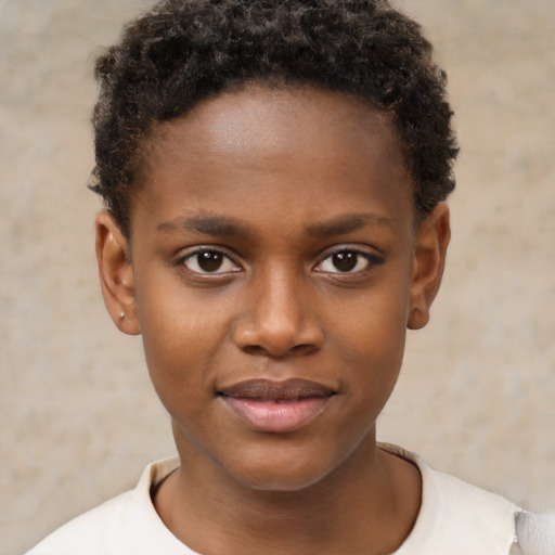 Joyful black child male with short  brown hair and brown eyes