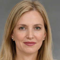 Joyful white adult female with long  brown hair and grey eyes