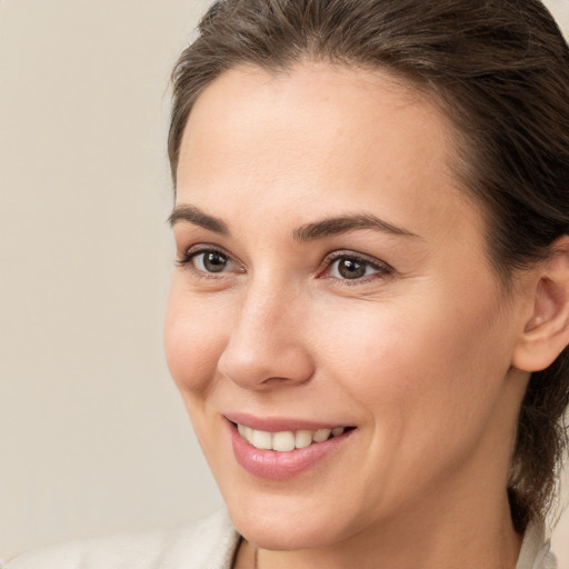 Joyful white young-adult female with medium  brown hair and brown eyes